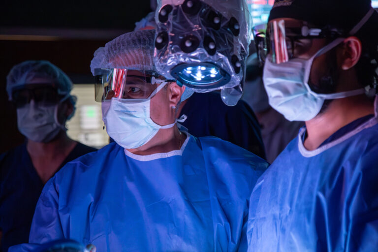 A team of doctors masked and scrubbed ready to start a photodynamic therapy treatment.